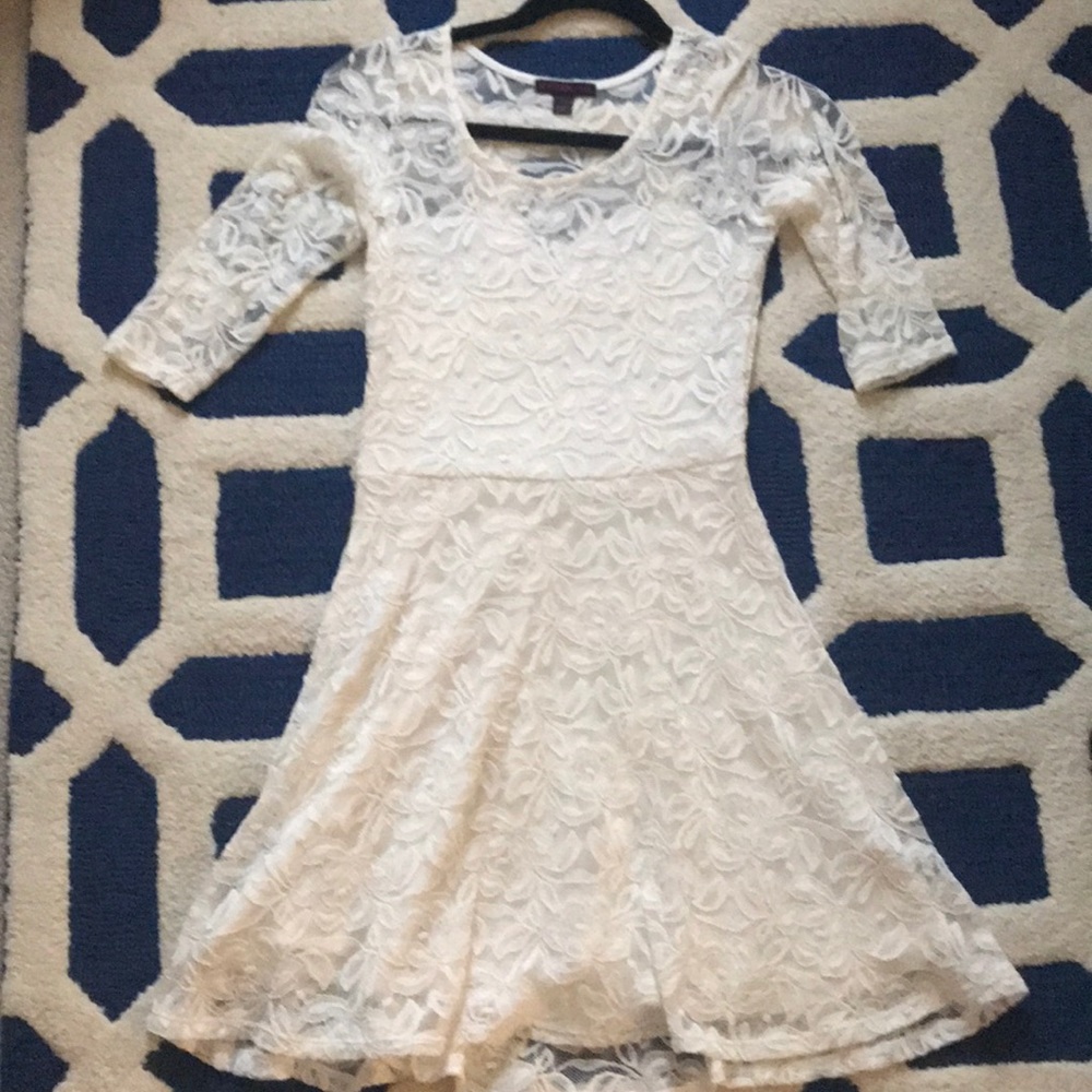 White lace dress with sweetheart neckline.